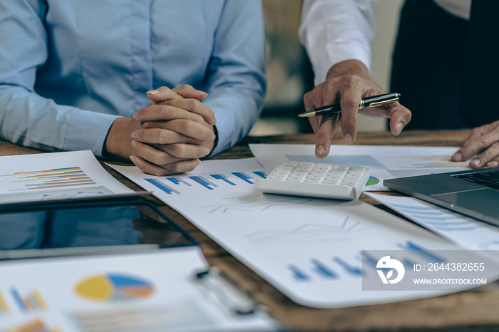 Businessman working on stock market investment chart with financial data analysis Two business colleagues discussing financial and company planning graphs during budget meeting in office room