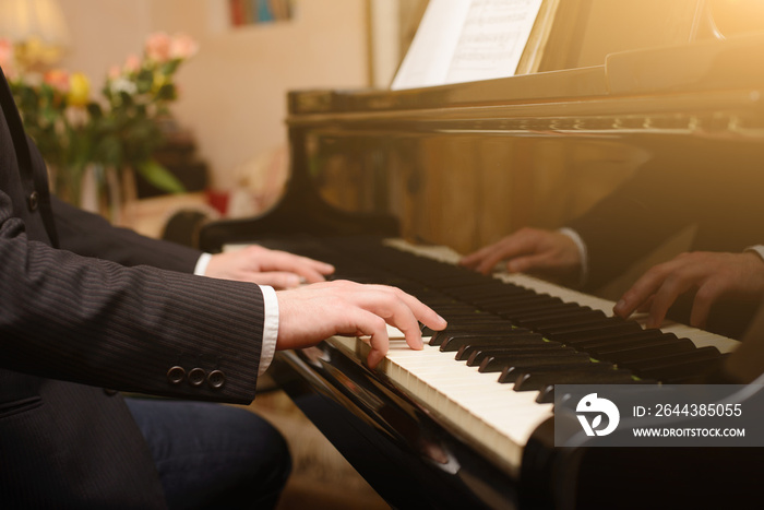 Close-up of a music performer’s hand playing the piano