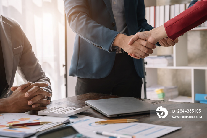 Businessmen shake hands after agreeing to start a new project successfully.