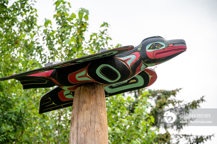 Tlinget totem poles, long house and traditional art in Saxman Alaska.