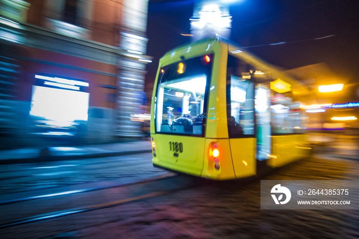 Lviv night blurred tram on historical beautiful streets with deep colorful light