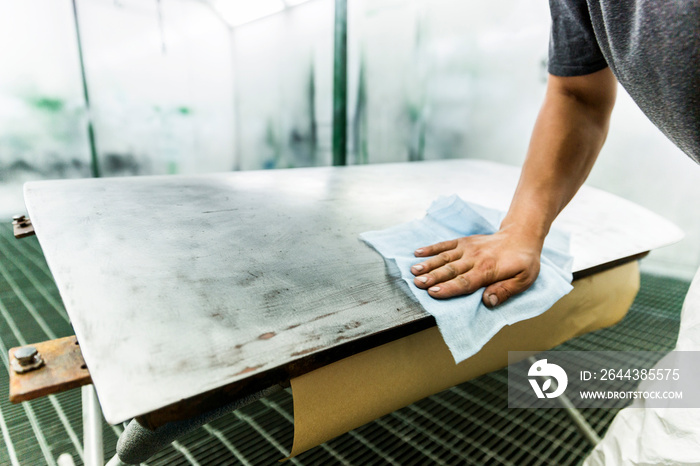 Polishing automotive car door before primer paint application.