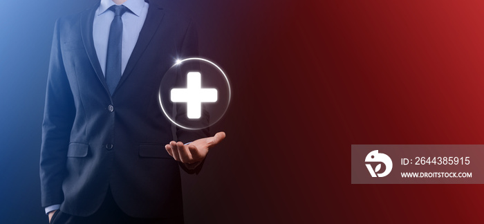 Businessman hold virtual plus medical network connection icons. Covid-19 pandemic develop people awareness and spread attention on their healthcare.