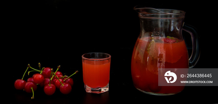 Compote with cherries and mint on a black background