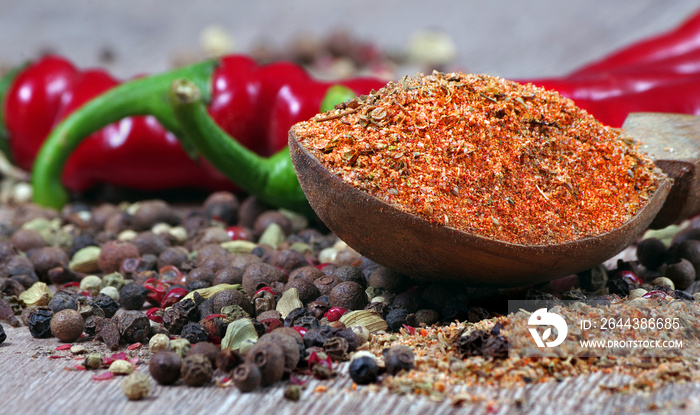 mixture of different peppers on a wooden table. traditional spices.