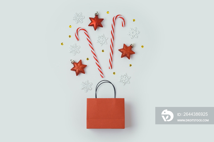 Christmas holiday concept with paper bag and decorations on white background.