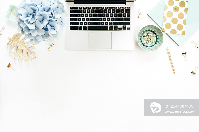 Home office desk workspace with laptop, hydrangea flowers bouquet, accessories on white background. Flat lay, top view decorated mockup.