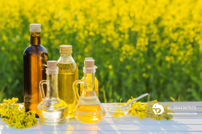 rapeseed oil on wooden table in field