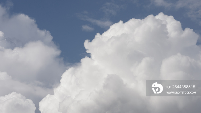 Puffy white clouds on blue sky