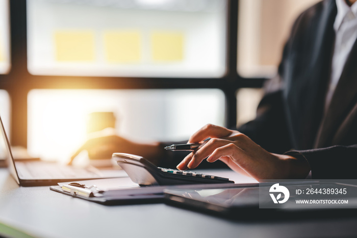 Portrait of a woman working on a tablet computer in a modern office. Make an account analysis report. real estate investment information financial and tax system concepts