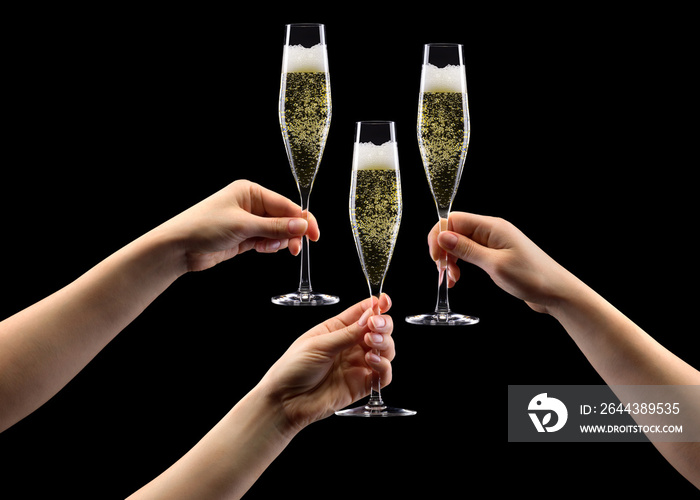 Set of hands holding glass of sparkling champagne isolated on black.