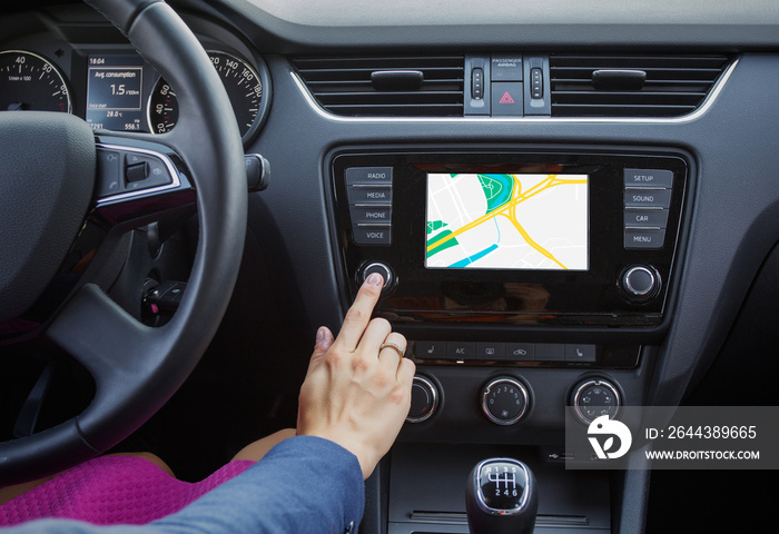 Woman using navigation system while driving a car