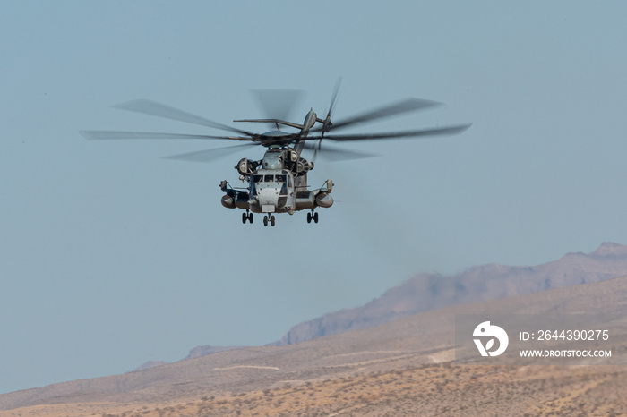 CH-53 Sea Stallion helicopter in flight, against the Nevada hills