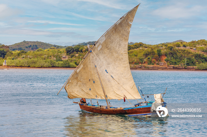 Malagasy fisher man on sea in traditional handmade dugout wooden sailing boat. Everyday life on Nosy be island. Nosy be, Madagascar