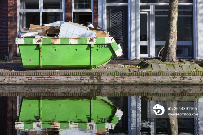 Builders skip near a canal in Gouda