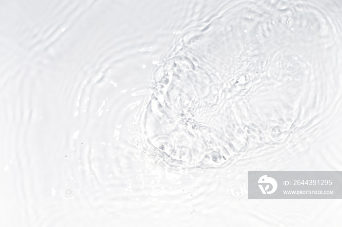 White, transparent and clear water surface with splashes and little bubbles. Water texture. Close up view. Trendy abstract nature background.