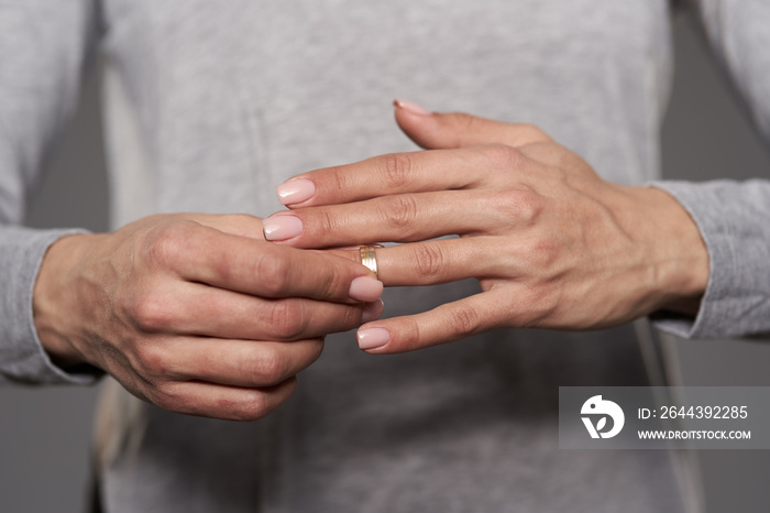 Woman taking off wedding ring