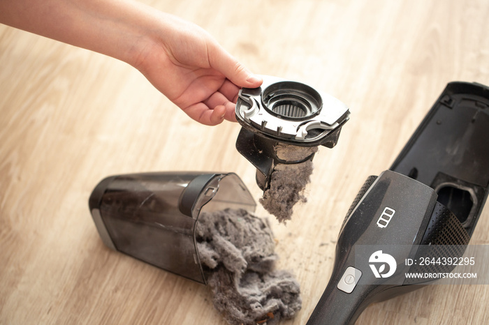 Close up of massively clogged, dirty filter of hand vacuum cleaner, dust and powder on the vacuum filter, household