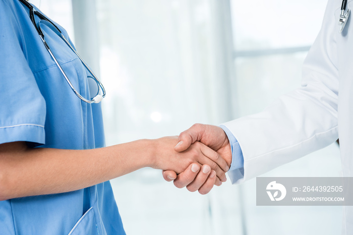 doctor and nurse shaking hands