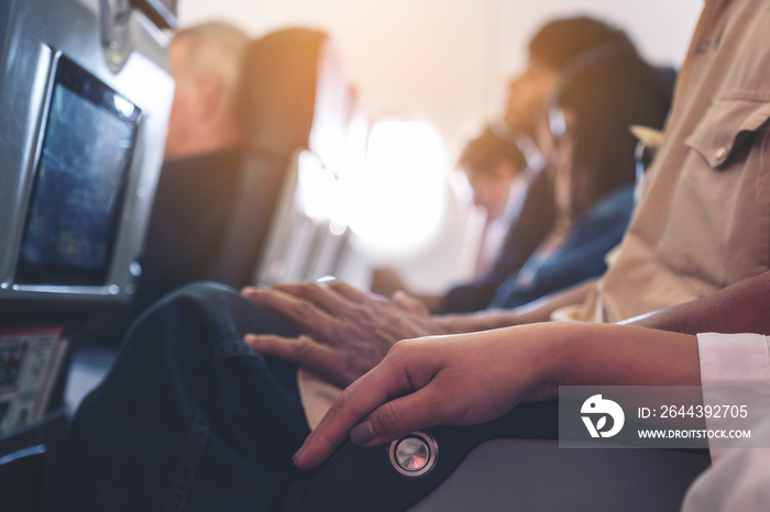 Passenger sitting on a seat row in cabin