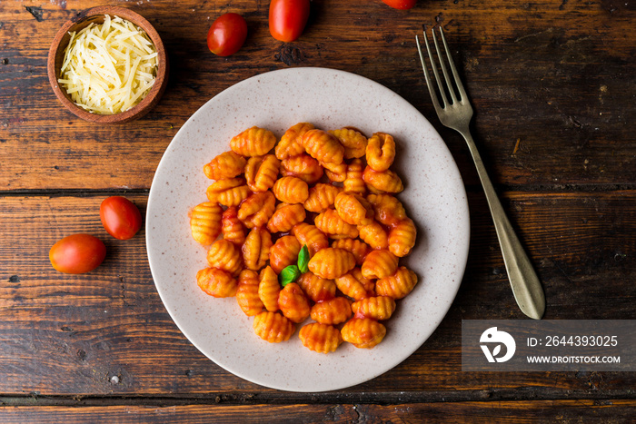 Gnocchi with tomato sauce, basil, and cheese, traditional Italian pasta food made of potatoes and flour