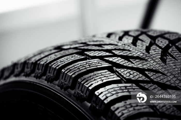 Stack of brand new high performance car tires on clean high-key white studio background. new car tire background. close up of texture