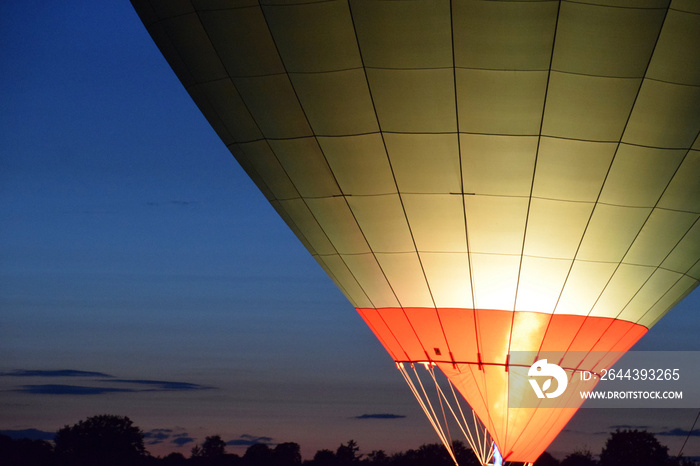 single air balloon with burner close-up, hot air balloon with a yellow fire from a burner by night