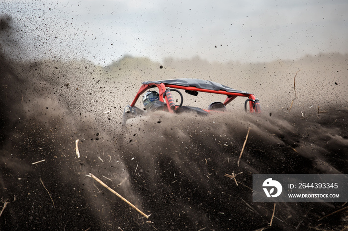 Quad bike with flying lumps of straw and straw