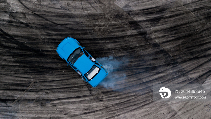 Drifting car on asphalt road with texture and background tire skid mark, Aerial view professional driver acceleration drifting car on race track with smoke, Automobile and automotive car concept