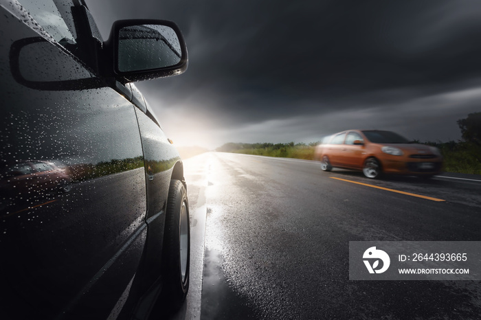 Black compact SUV car with storm clouds as background,transportation during bad weather condition concept.