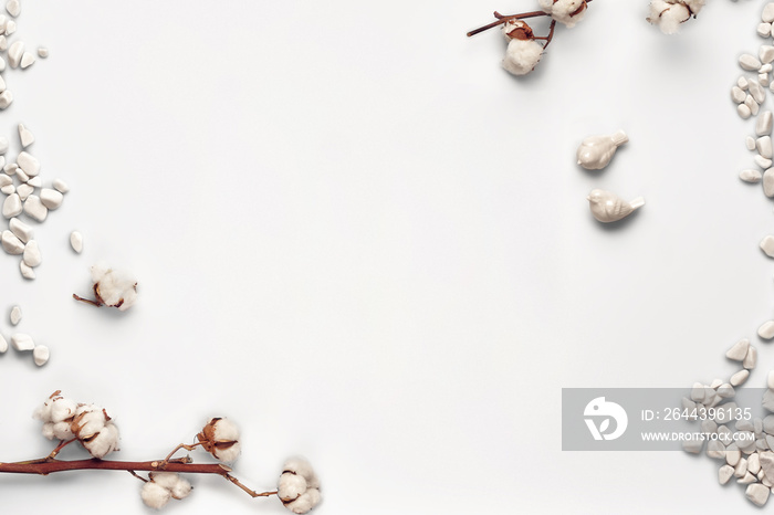 Flowers of cotton, sea stones and two small ceramic birds isolated on white background. Close up, copy space, mock up. Top view, flat lay