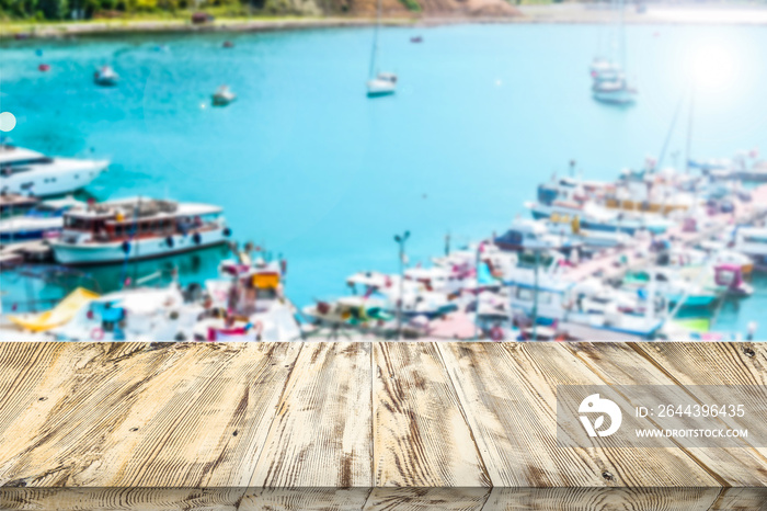 Blank white wooden table against the sail and yacht port. Empty copy space for your products. Marine or sea lifestyle theme for advertising display space.