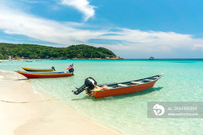 Boats with clear water and blue skies at Perhentian Island, Malaysia