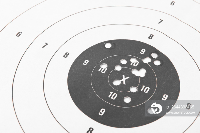 Close up of a shooting target and bullseye with bullet holes