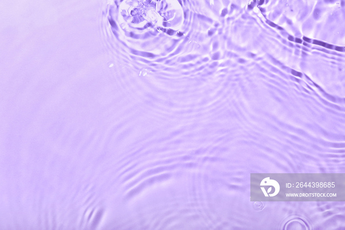 Clean water with splashes on color background