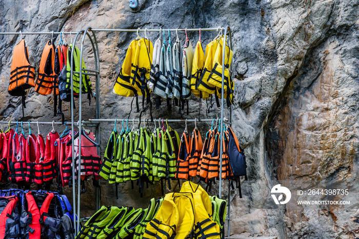 Many life vests on a hangers in canyon