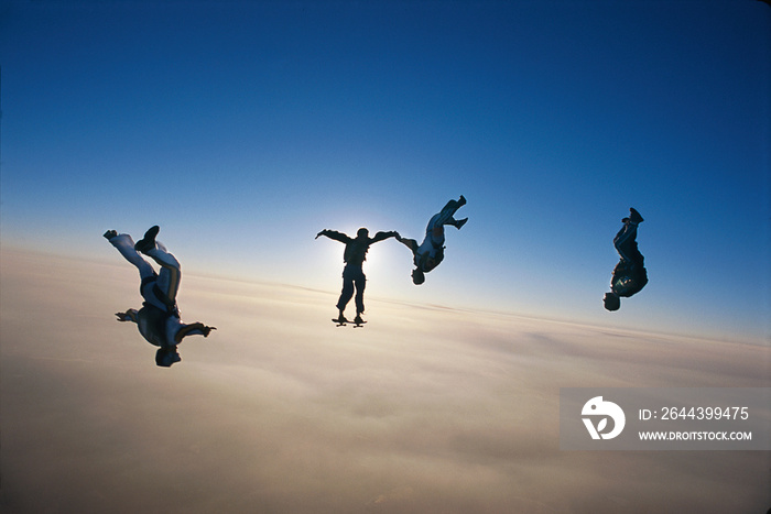 skydiving group of people above the clouds