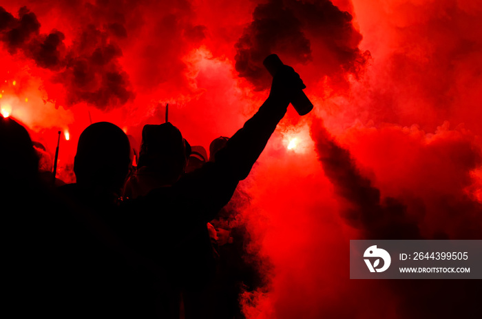 Football fans burn the lights and smoke bombs. The concept of aggression