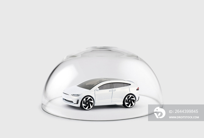 Modern white car protected under a glass dome