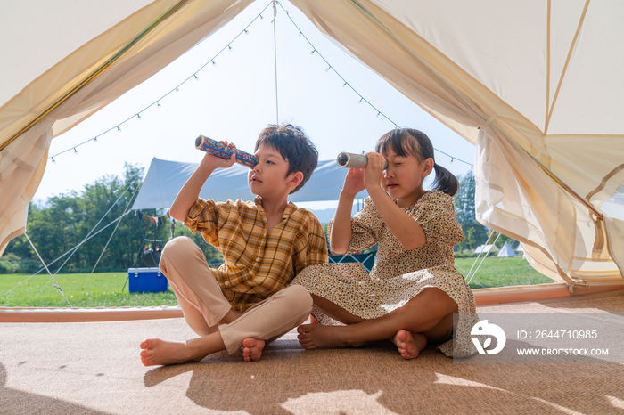 两个孩子坐在帐篷里玩耍