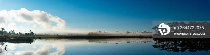 Extra wide panoramic view of sunrise over the lake in nation park, Beautiful rainforest landscape with fog in morning, Thailand.