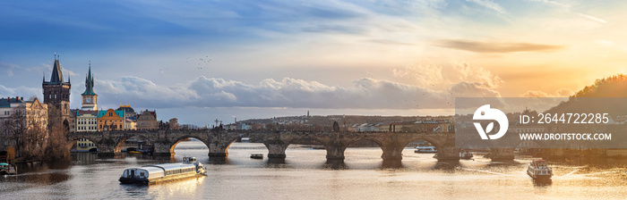 Prague, Czech Republic - Panoramic view of the world famous Charles Bridge (Karluv most) on a sunny winter afternoon with beautiful golden sunset and sky