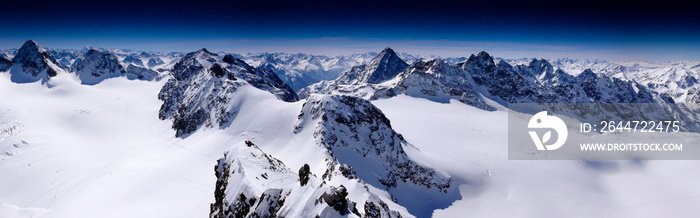 fantastic winter mountain panorama with a view of the high peaks and glaciers of the Silvretta mountains in the Swiss Alps on a beautiful winter day