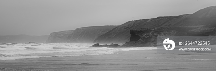 Beautiful landscape of ocean beach and mountains, black and white