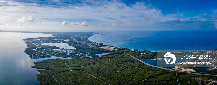 aerial drone footage of the island of grand cayman in the cayman islands in the clear blue and green tropical waters of the caribbean sea