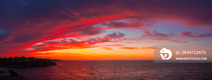 Drone aerial view of a Fiery sunrise with multicolored clouds. Mallorca Island, Spain. Summer season