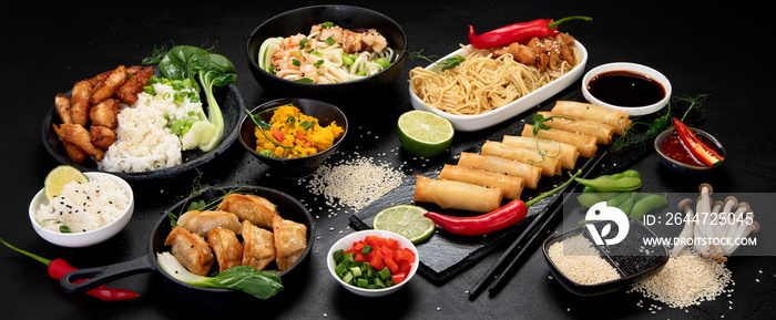 Assorted asian dishes and snacks on black background. Traditional food concept.