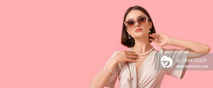 Portrait of pretty woman wearing stylish eyeglasses and jewelry on pink background with space for text