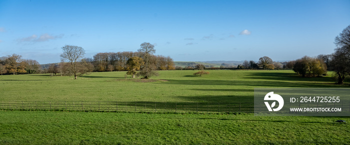 view across the front of a country manor estate, blue sky