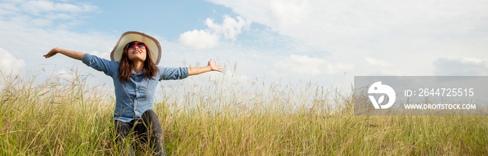 Let it go Freedom hand and Release concept. Lifestyle of Young girl spread hand against green field background. Person front view of freedom and traveler asian woman, banner for web header.